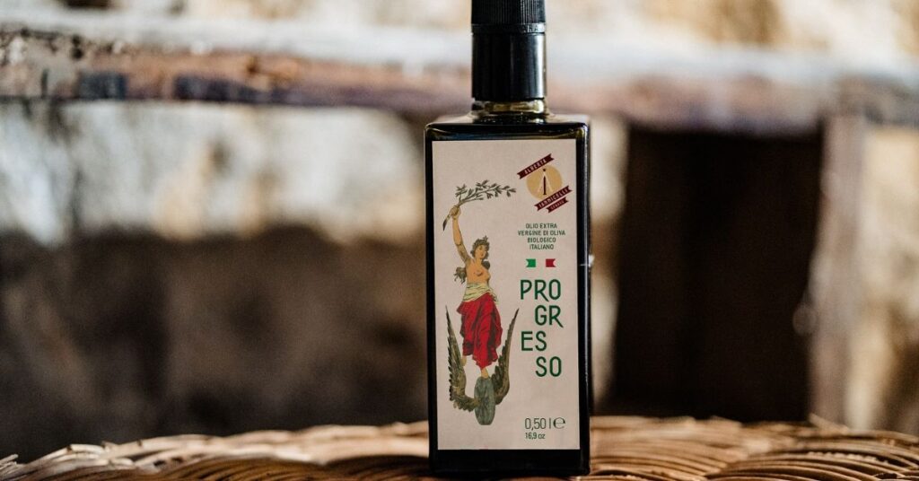 Bottle of Alberta Iannicelli olive oil on a rustic wooden table, showcasing traditional Italian craftsmanship." "Bottle of Alberta Iannicelli extra virgin olive oil on a rustic wooden table, showcasing traditional Italian craftsmanship." "Bottle of Alberta Iannicelli extra virgin olive oil on a rustic wooden table, showcasing traditional Italian craftsmanship." "Bottle of Alberta Iannicelli extra virgin olive oil on a rustic wooden table, showcasing traditional Italian craftsmanship.