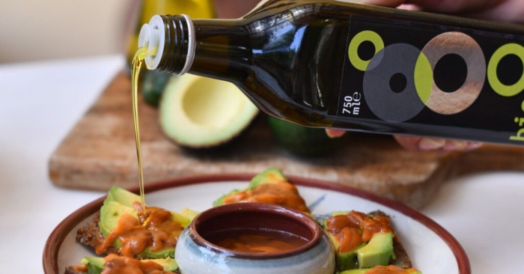 Anoskeli olive oil bottle pourimg on dish