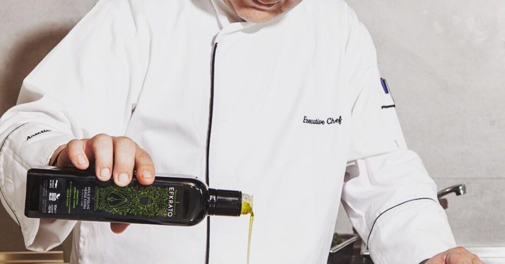 Chef pouring Efkrato Olive Oil onto a dish for finishing touch