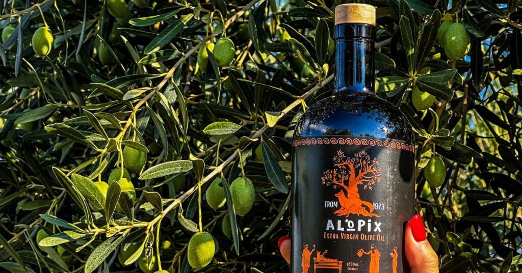 Alopix olive oil bottle with olive tree as a background